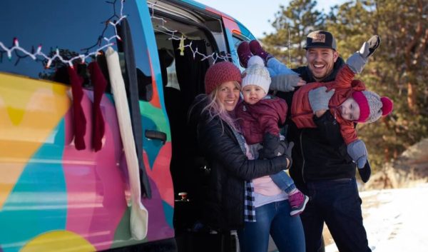 Family with campervan and Christmas lights