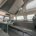 The Del Mar campervans' interior seating area with the upper bed stowed. 