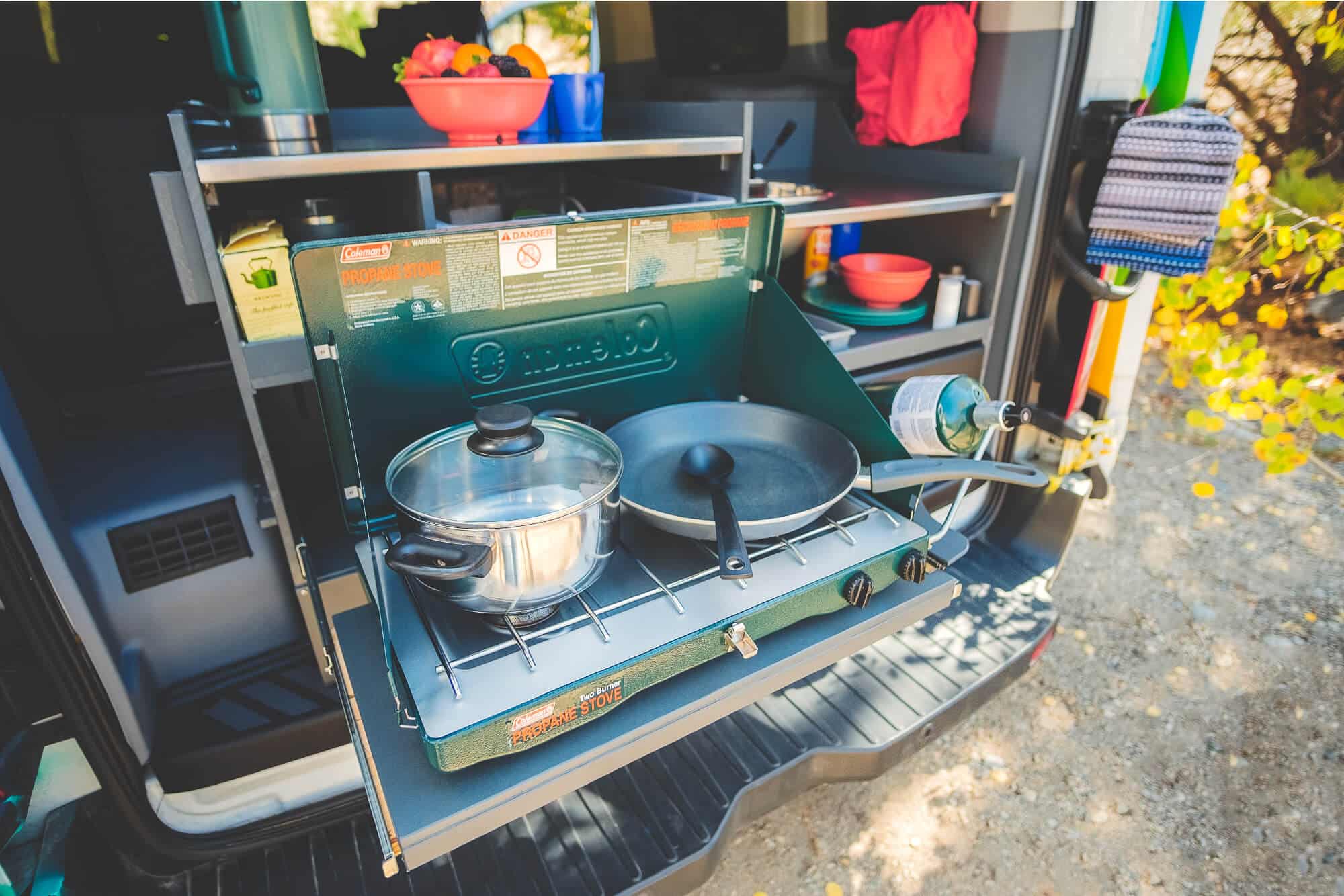 Two burner propane stove in the kitchen of an Escape Camper Van.