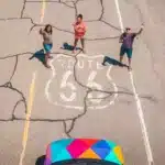 People standing on Route 66 in front of an Escape Camper Van.