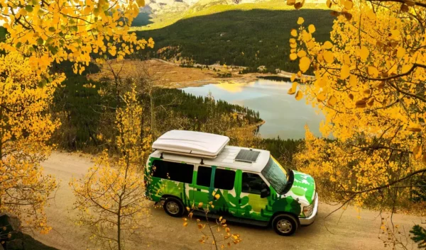 An Escape Camper Van driving Boreas Pass in the Fall.