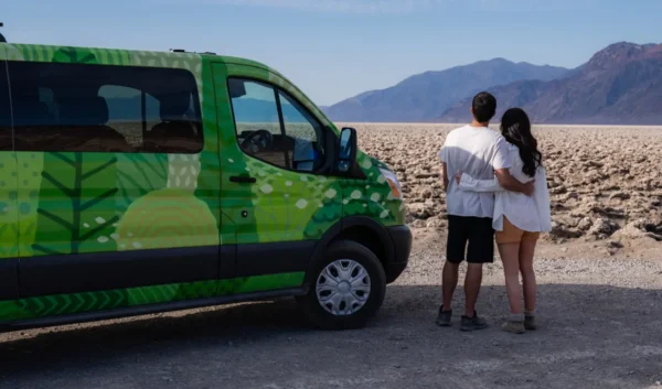 Couple hugging beside an Escape Camper Van