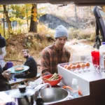 A group of friends cooking and easy camping breakfast together.