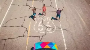 People standing on Route 66 in front of an Escape Camper Van.